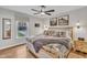 Bright bedroom with modern ceiling fan, patterned bedding, and natural light from the window at 305 Dickens Rd, Fuquay Varina, NC 27526