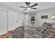 Cozy bedroom with natural light, ceiling fan, and ample closet space at 305 Dickens Rd, Fuquay Varina, NC 27526
