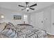 Bedroom showcasing a ceiling fan, modern closet, and television with exterior view at 305 Dickens Rd, Fuquay Varina, NC 27526