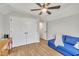 Cozy bonus room with bright blue couch, natural light, and updated closet space at 305 Dickens Rd, Fuquay Varina, NC 27526