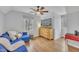 Bright bonus room featuring a ceiling fan, comfortable blue couch and exterior view from the window at 305 Dickens Rd, Fuquay Varina, NC 27526