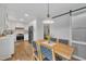 Open-concept dining area with direct views of the kitchen and access to the back deck at 305 Dickens Rd, Fuquay Varina, NC 27526