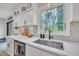 Stylish kitchen sink with white cabinetry, modern fixtures, and a great view of the outdoors at 305 Dickens Rd, Fuquay Varina, NC 27526