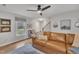 Comfortable living room with a leather couch, ceiling fan, and natural light at 305 Dickens Rd, Fuquay Varina, NC 27526