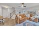 Open-concept living room with a comfortable leather sofa and modern decor at 305 Dickens Rd, Fuquay Varina, NC 27526