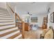 Bright living area with hardwood floors, modern stair railing, and ample natural light at 305 Dickens Rd, Fuquay Varina, NC 27526