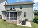Backyard view featuring a screened in porch and patio with grill at 309 Orange Blossom Ct, Wake Forest, NC 27587