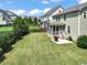 Large grassy backyard and rear exterior view featuring screened in porch at 309 Orange Blossom Ct, Wake Forest, NC 27587