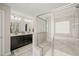 Luxurious bathroom with double vanity, glass shower, and tile throughout at 309 Orange Blossom Ct, Wake Forest, NC 27587