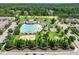 Aerial view of a community pool and green space surrounded by trees at 309 Orange Blossom Ct, Wake Forest, NC 27587
