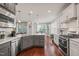 Bright, spacious kitchen with stainless appliances, white cabinetry, and a large island at 309 Orange Blossom Ct, Wake Forest, NC 27587