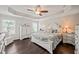 Spacious main bedroom with hardwood floors, tray ceiling, and a comfortable bed at 309 Orange Blossom Ct, Wake Forest, NC 27587