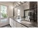 Bathroom featuring double sinks, marble countertops and ample lighting at 321 E Lane St, Raleigh, NC 27601