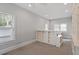Bright bedroom featuring neutral walls, large windows, and built-in shelving for storage and display at 321 E Lane St, Raleigh, NC 27601