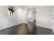 Hardwood floors and white walls lend a bright, spacious feel to this room, lit by natural light through a nearby window at 321 E Lane St, Raleigh, NC 27601