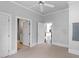 Neutral bedroom featuring carpeted floor, overhead lighting, and doors to bathrooms and kitchen at 321 E Lane St, Raleigh, NC 27601