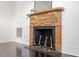 A carved, decorative fireplace stands against a white wall with dark hardwood floors at 321 E Lane St, Raleigh, NC 27601