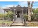 Charming historic home featuring a covered porch with detailed columns and inviting entryway, landscaping, and mature trees at 321 E Lane St, Raleigh, NC 27601