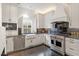 Bright kitchen features stainless appliances, white cabinets, and a farmhouse sink at 321 E Lane St, Raleigh, NC 27601