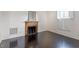 Living room with dark hardwood floors and fireplace with decorative mantle and a large mirror above at 321 E Lane St, Raleigh, NC 27601