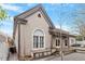 Rear exterior view of the home, showcasing the siding, an arched window, a small deck, and a well-maintained yard at 321 E Lane St, Raleigh, NC 27601