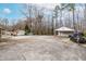 Backyard features a detached garage, shed, and mature trees for privacy at 3617 Cranston Rd, Garner, NC 27529