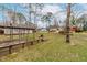 A spacious backyard featuring a garden, mature trees, and a partial view of the home's exterior at 3617 Cranston Rd, Garner, NC 27529