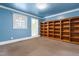 Bedroom space features a large bookcase and neutral carpeting at 3617 Cranston Rd, Garner, NC 27529