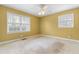 Bedroom with carpet flooring features two windows and ceiling fan at 3617 Cranston Rd, Garner, NC 27529