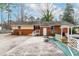 An exterior view of the rear of the home showing the brick facade and concrete patio at 3617 Cranston Rd, Garner, NC 27529