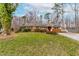 Charming brick home featuring a well-maintained lawn and mature trees, with a pop of color from the red front door at 3617 Cranston Rd, Garner, NC 27529