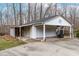 A detached white garage has space for two cars with additional covered parking at 3617 Cranston Rd, Garner, NC 27529