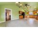 Spacious green kitchen area with modern appliances and wood cabinets, connecting to another room in the home at 3617 Cranston Rd, Garner, NC 27529