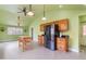 Bright kitchen features an island, stainless steel refrigerator, and wooden cabinets at 3617 Cranston Rd, Garner, NC 27529