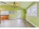 Light green kitchen with modern lighting, a vaulted ceiling, and a door leading to the backyard at 3617 Cranston Rd, Garner, NC 27529