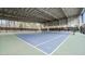 Indoor tennis court with blue and green flooring, netting, and metal frame at 3908 Cash Rd, Durham, NC 27703