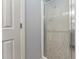 Bathroom door next to enclosed shower featuring patterned frosted glass and bright trim at 402 Abbott Dr, Sanford, NC 27330