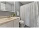 Bathroom featuring a white vanity, toilet, and a shower with a patterned black and white curtain at 402 Abbott Dr, Sanford, NC 27330