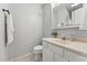 Bathroom with marble style countertops, white cabinets, towel hooks, and updated faucet at 402 Abbott Dr, Sanford, NC 27330