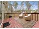 Back deck featuring outdoor seating, a stained wood railing and deck with backyard views at 402 Abbott Dr, Sanford, NC 27330