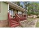 Close up of home's covered front porch with steps and lattice at 402 Abbott Dr, Sanford, NC 27330