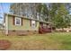 Charming single-story home featuring a covered front porch with red shutters and brick foundation at 402 Abbott Dr, Sanford, NC 27330