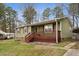 Lovely single-story home with a covered porch with detailed woodwork and brick accents at 402 Abbott Dr, Sanford, NC 27330