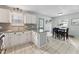 Bright kitchen with granite counters, white cabinets, dining table, and tile floors at 402 Abbott Dr, Sanford, NC 27330
