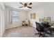 Bright office featuring neutral carpet and walls, modern ceiling fan, and a desk and seating area at 402 Abbott Dr, Sanford, NC 27330