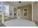 Covered back porch with access door and windows, ideal for enjoying the outdoors at 42 Chris Todd Way, Angier, NC 27501