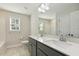 Bathroom featuring a dual sink vanity with modern fixtures and a well-lit mirror at 42 Chris Todd Way, Angier, NC 27501