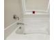 Relaxing bathtub with chrome fixtures and a bright window view for a serene bathing experience at 42 Chris Todd Way, Angier, NC 27501