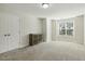 Spacious bedroom with carpet flooring, a double door closet, and a decorative cabinet at 42 Chris Todd Way, Angier, NC 27501