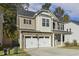 Attractive two-story home featuring a stone facade, a two-car garage, and neat landscaping at 42 Chris Todd Way, Angier, NC 27501